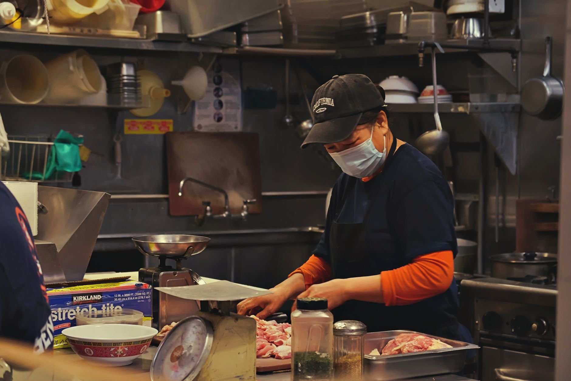 A professional catering team preparing food in a commercial kitchen